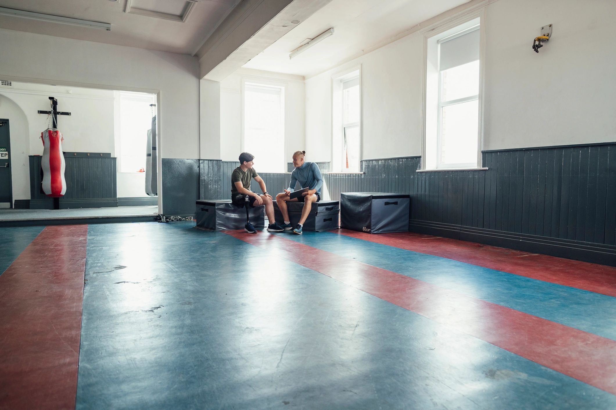 Young athlete training with a coach in a gym