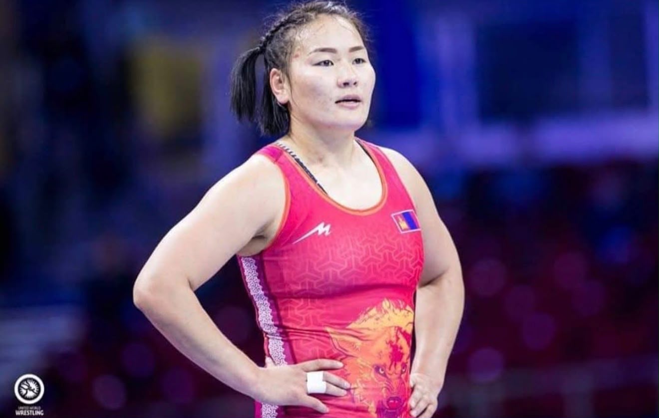 Coach Uka in competition attire at a wrestling event